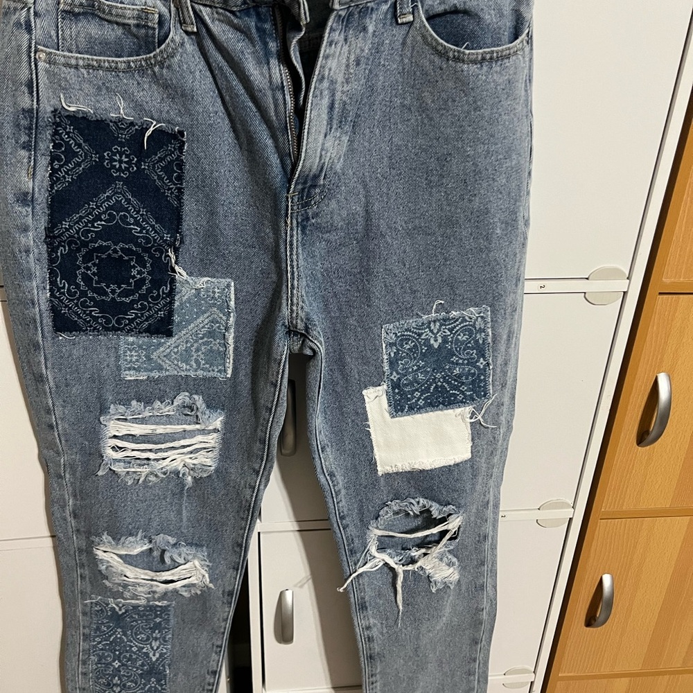Relaxed Blue Distressed Jeans with Rips and Patches